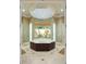 Opulent bathroom with large soaking tub, walk-in shower, and natural light at 3218 Signet Ct, Sarasota, FL 34240