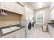 Bright laundry room with a sink and ample counter space at 3218 Signet Ct, Sarasota, FL 34240