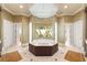 Large bathroom with a spacious soaking tub, double vanities, and a walk-in shower at 3218 Signet Ct, Sarasota, FL 34240