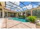 Enclosed pool and spa with covered patio and landscaping at 3218 Signet Ct, Sarasota, FL 34240