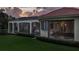 Landscaped backyard with covered patio and pool area at 3218 Signet Ct, Sarasota, FL 34240