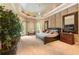 Luxurious main bedroom with a large bed and sitting area at 3218 Signet Ct, Sarasota, FL 34240