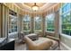 Relaxing sitting area with two chaise lounges and abundant natural light from large windows at 3218 Signet Ct, Sarasota, FL 34240