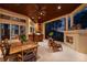 Covered patio with outdoor kitchen, fireplace, and dining area at 3218 Signet Ct, Sarasota, FL 34240