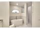 Modern bathroom featuring a soaking tub, walk-in shower with gray tiles and stylish fixtures at 15923 29Th E St, Parrish, FL 34219
