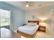 Cozy bedroom with neutral color scheme, wood-look accent wall, and comfortable carpeted floor at 15923 29Th E St, Parrish, FL 34219