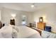 Well-lit bedroom featuring a wooden dresser, area rug, and sliding glass doors leading to the pool area at 15923 29Th E St, Parrish, FL 34219