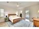 Bright bedroom with a wood frame bed, blue accent rug, and sliding doors leading to the pool area at 15923 29Th E St, Parrish, FL 34219