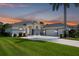 Beautiful single-story home with an attached three-car garage, a well-manicured lawn, and lovely landscaping at 15923 29Th E St, Parrish, FL 34219