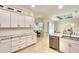 Elegant kitchen with white cabinets, granite countertops, tile backsplash, and stainless steel appliances at 15923 29Th E St, Parrish, FL 34219