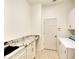 Functional laundry room with granite counters and cabinets for storage at 15923 29Th E St, Parrish, FL 34219