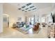Spacious living room with a decorative coffered ceiling, tile flooring, comfortable seating, and bright, airy ambiance at 15923 29Th E St, Parrish, FL 34219