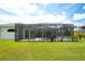 Enclosed pool and backyard with lush green grass at 15923 29Th E St, Parrish, FL 34219