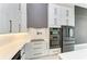 Modern kitchen features white cabinets, stainless steel appliances, and quartz countertops at 13457 Drysdale Ave, Port Charlotte, FL 33981