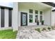 Modern entryway with a unique door and paver patio at 13457 Drysdale Ave, Port Charlotte, FL 33981