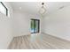 Bedroom with pool view, sliding glass doors and modern light fixture at 13457 Drysdale Ave, Port Charlotte, FL 33981