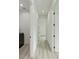 Bright hallway with light grey wood-look floors and white walls at 13457 Drysdale Ave, Port Charlotte, FL 33981