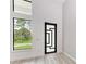 Modern entryway with black door and large window at 13457 Drysdale Ave, Port Charlotte, FL 33981
