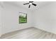 Spacious bedroom with ceiling fan and large window at 13457 Drysdale Ave, Port Charlotte, FL 33981