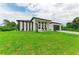 Modern house with a gray garage door and green lawn at 13457 Drysdale Ave, Port Charlotte, FL 33981