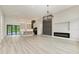Open living room with modern fireplace, large windows, and hardwood floors at 13457 Drysdale Ave, Port Charlotte, FL 33981