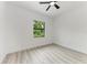 Simple bedroom with ceiling fan and large window at 13457 Drysdale Ave, Port Charlotte, FL 33981