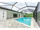 Inviting pool area with a screened enclosure and patio at 13457 Drysdale Ave, Port Charlotte, FL 33981