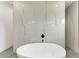 Bathroom featuring a freestanding bathtub and marble-look tile at 13457 Drysdale Ave, Port Charlotte, FL 33981
