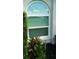 Exterior featuring arched window with landscaping at 5333 Kelly Dr # 6, Sarasota, FL 34233