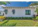 Landscaped yard with gray shutters and lush green grass at 5932 Red Mangrove Ln, Bradenton, FL 34210