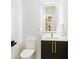 Stylish powder room with wave patterned tile and gold fixtures at 2170 Fruitville Rd, Sarasota, FL 34237