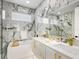 Spa-like bathroom with marble tile and gold fixtures at 2170 Fruitville Rd, Sarasota, FL 34237