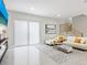 Bright living room with white sofa, patterned rug, and large window at 2170 Fruitville Rd, Sarasota, FL 34237
