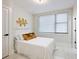 Bright bedroom with a white queen-size bed and gold accents at 2170 Fruitville Rd, Sarasota, FL 34237
