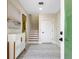 Bright entryway with stairs, a rug, and a white cabinet at 2170 Fruitville Rd, Sarasota, FL 34237