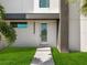 Modern home exterior with glass door and landscaping at 2170 Fruitville Rd, Sarasota, FL 34237