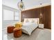 Main bedroom with wood accent wall and plush bedding at 2170 Fruitville Rd, Sarasota, FL 34237