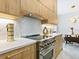 Modern kitchen with light wood cabinets, marble backsplash, and stainless steel appliances at 2170 Fruitville Rd, Sarasota, FL 34237
