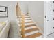 Modern staircase with light wood treads and gold accents at 2170 Fruitville Rd, Sarasota, FL 34237