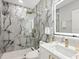 Modern bathroom with marble shower and gold fixtures at 2170 Fruitville Rd, Sarasota, FL 34237