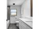 Clean bathroom with double vanity, grey tile floors and bathtub at 430 Tanager Rd, Venice, FL 34293