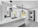 Modern kitchen with white cabinets, stainless steel appliances, and quartz countertops at 430 Tanager Rd, Venice, FL 34293