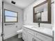 Modern bathroom with white vanity, quartz countertop, and gray tile floor at 430 Tanager Rd, Venice, FL 34293