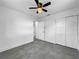 Spacious bedroom with grey tile floors and double door closet at 430 Tanager Rd, Venice, FL 34293