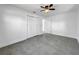 Bright bedroom with grey tile floors and a double door closet at 430 Tanager Rd, Venice, FL 34293