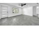 Open living room with grey tile floors and ceiling fan at 430 Tanager Rd, Venice, FL 34293