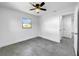 Simple bedroom with grey tile floors and access to bathroom at 430 Tanager Rd, Venice, FL 34293