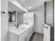 Clean bathroom with double vanity and a large mirror at 430 Tanager Rd, Venice, FL 34293
