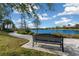 Serene lakeside bench offering peaceful views at 12710 Sorrento Way # 101, Bradenton, FL 34211