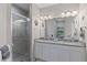 Elegant bathroom with double vanity, granite countertop, and walk-in shower at 12710 Sorrento Way # 101, Bradenton, FL 34211